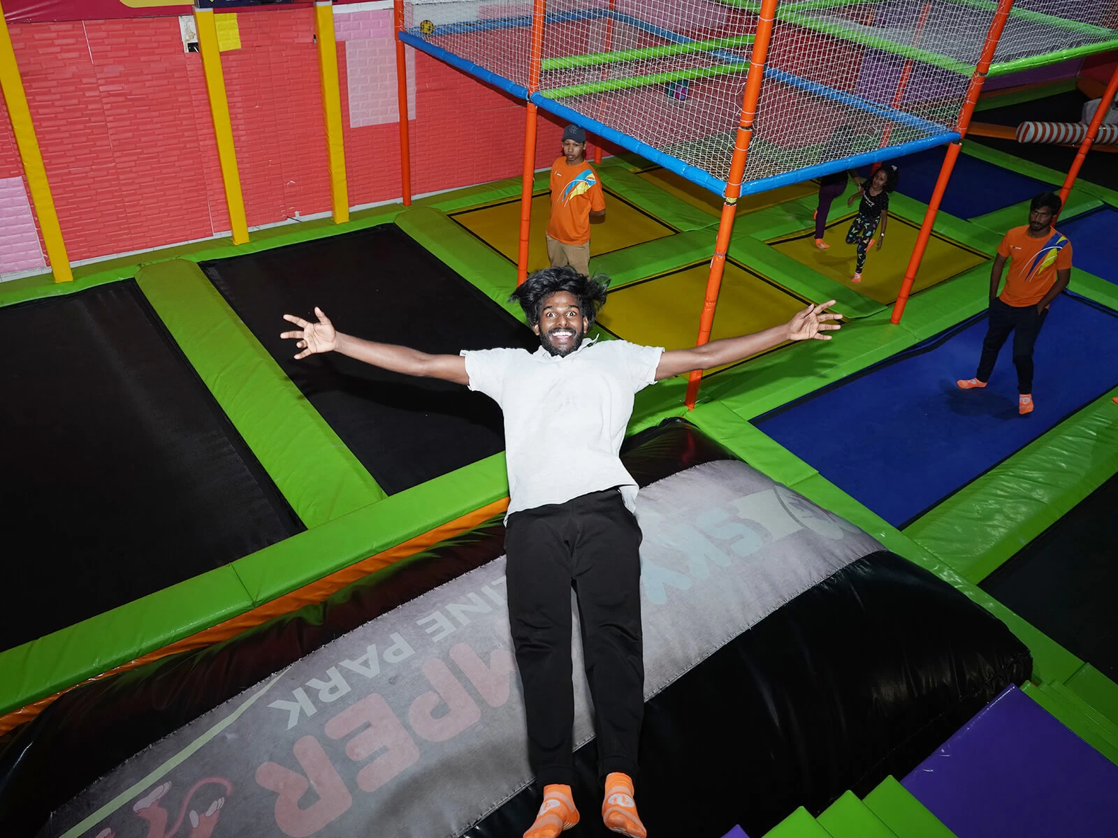 a person posing for a photo while jumping on trampoline