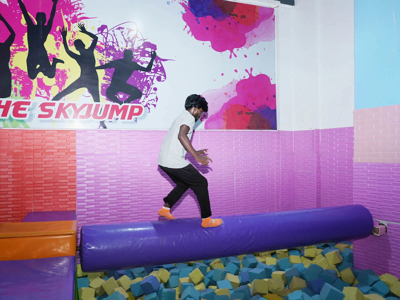 a guy playing in foam pit at skyjumper