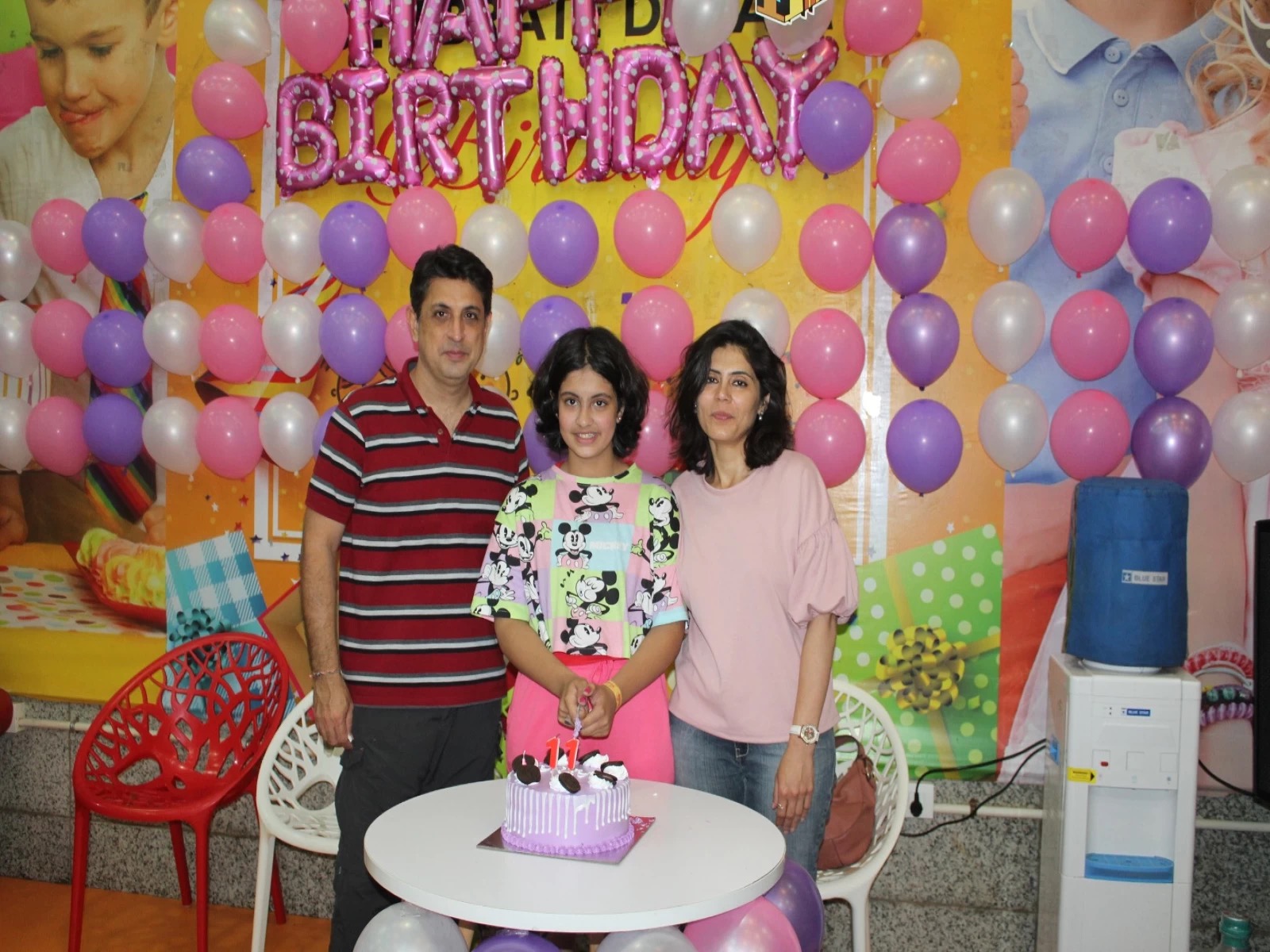 girl posing for a photo with her parents at skyJumper