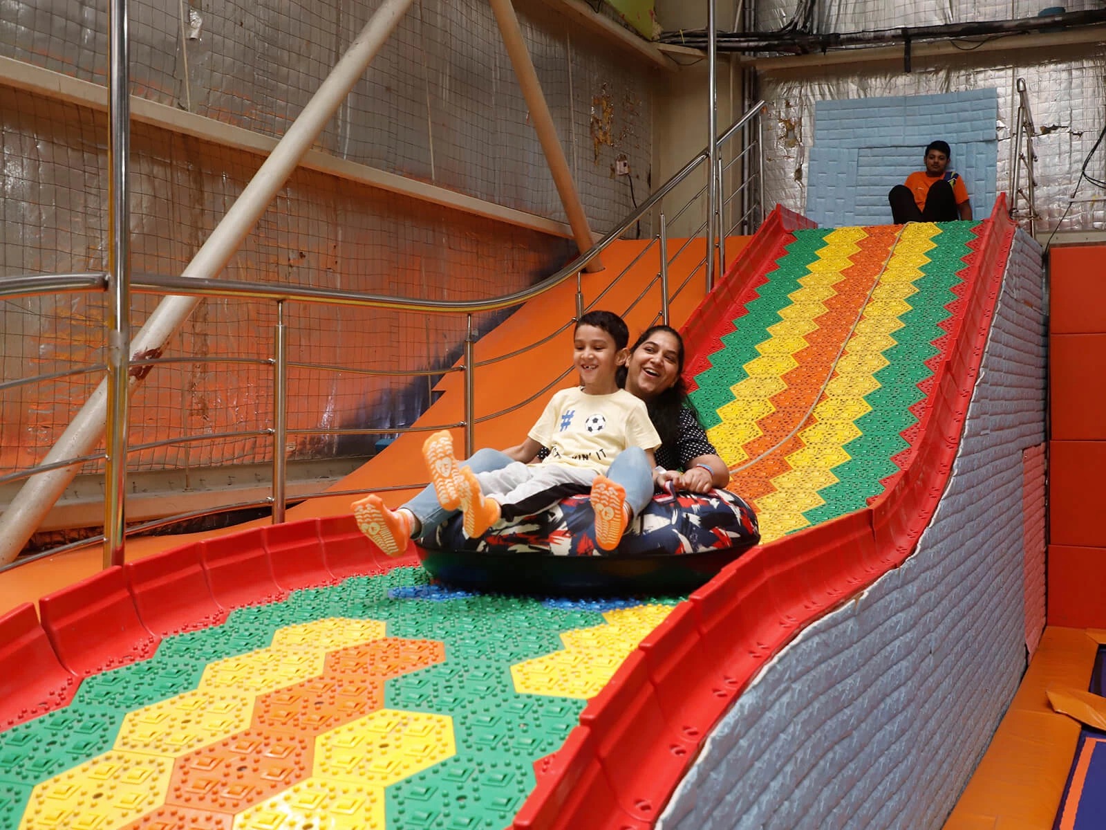 people enjoying sliding down at skyjumper