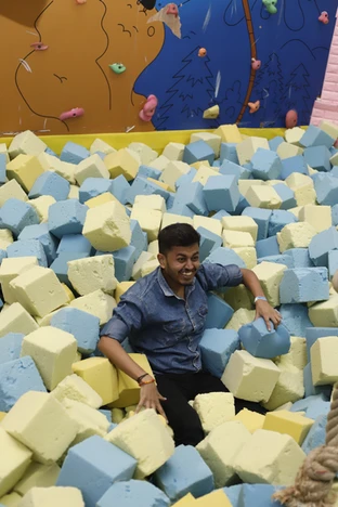a guy playing in foam pit at skyjumper