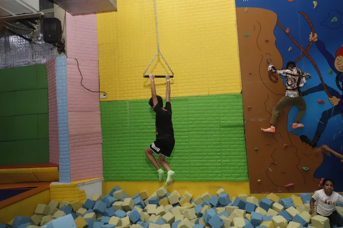 kid jumping in foam pit at skyjumper