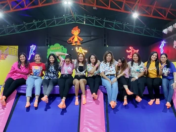group of ladies sitting in trampoline arena at skyjumper