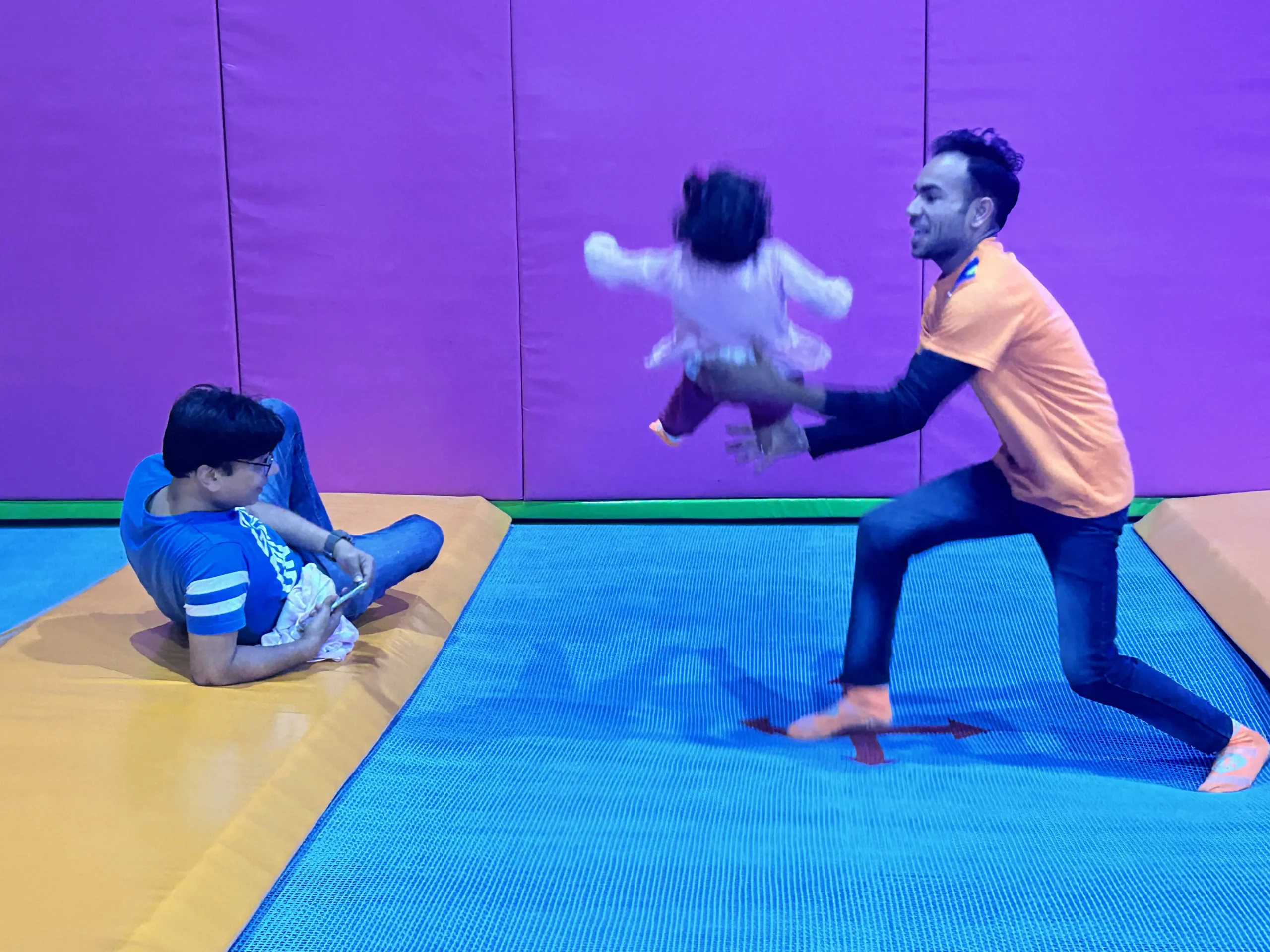 trained staff catching a jumping kid at skyjumper