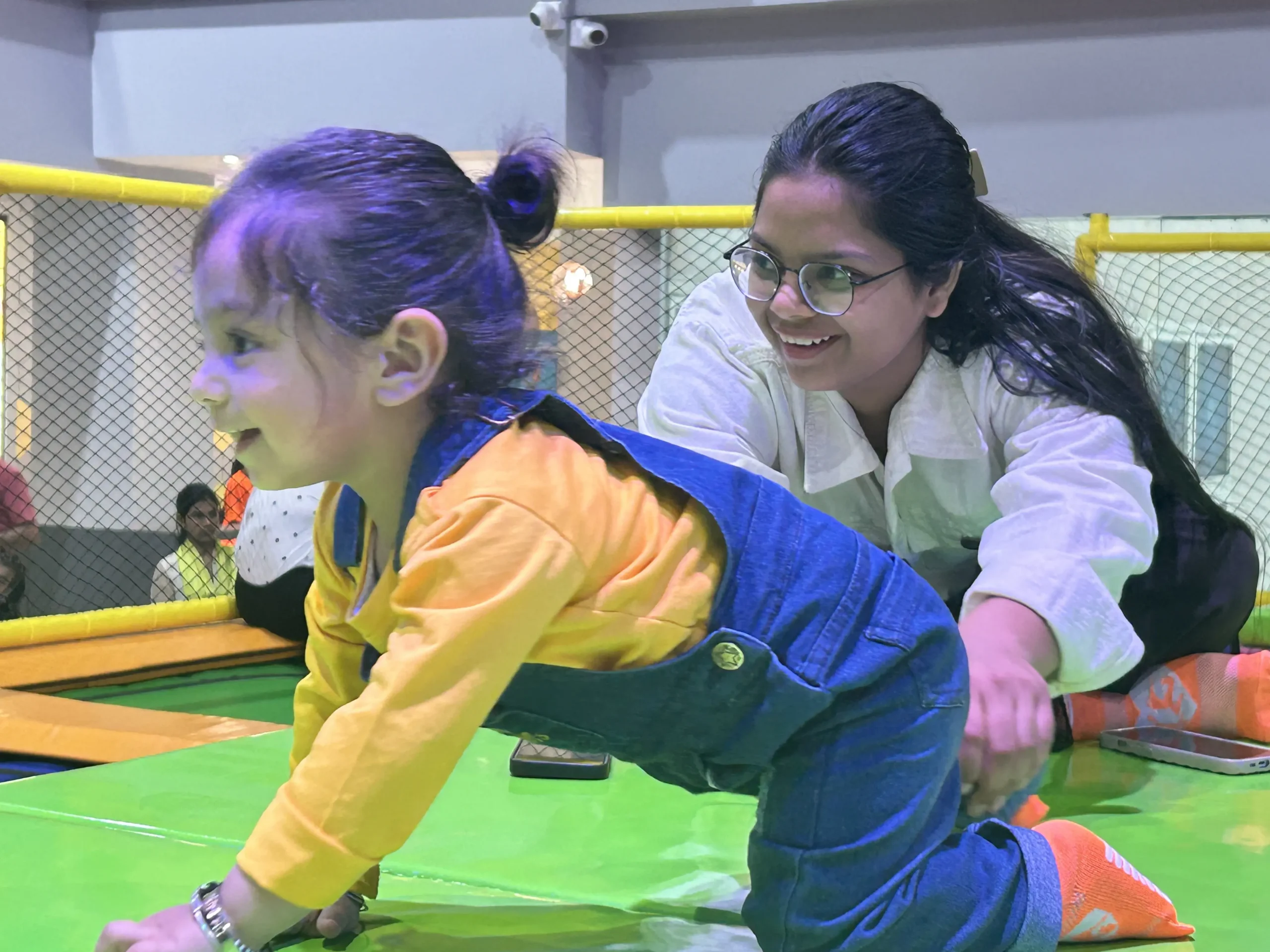 a kid sitting on trampoline
