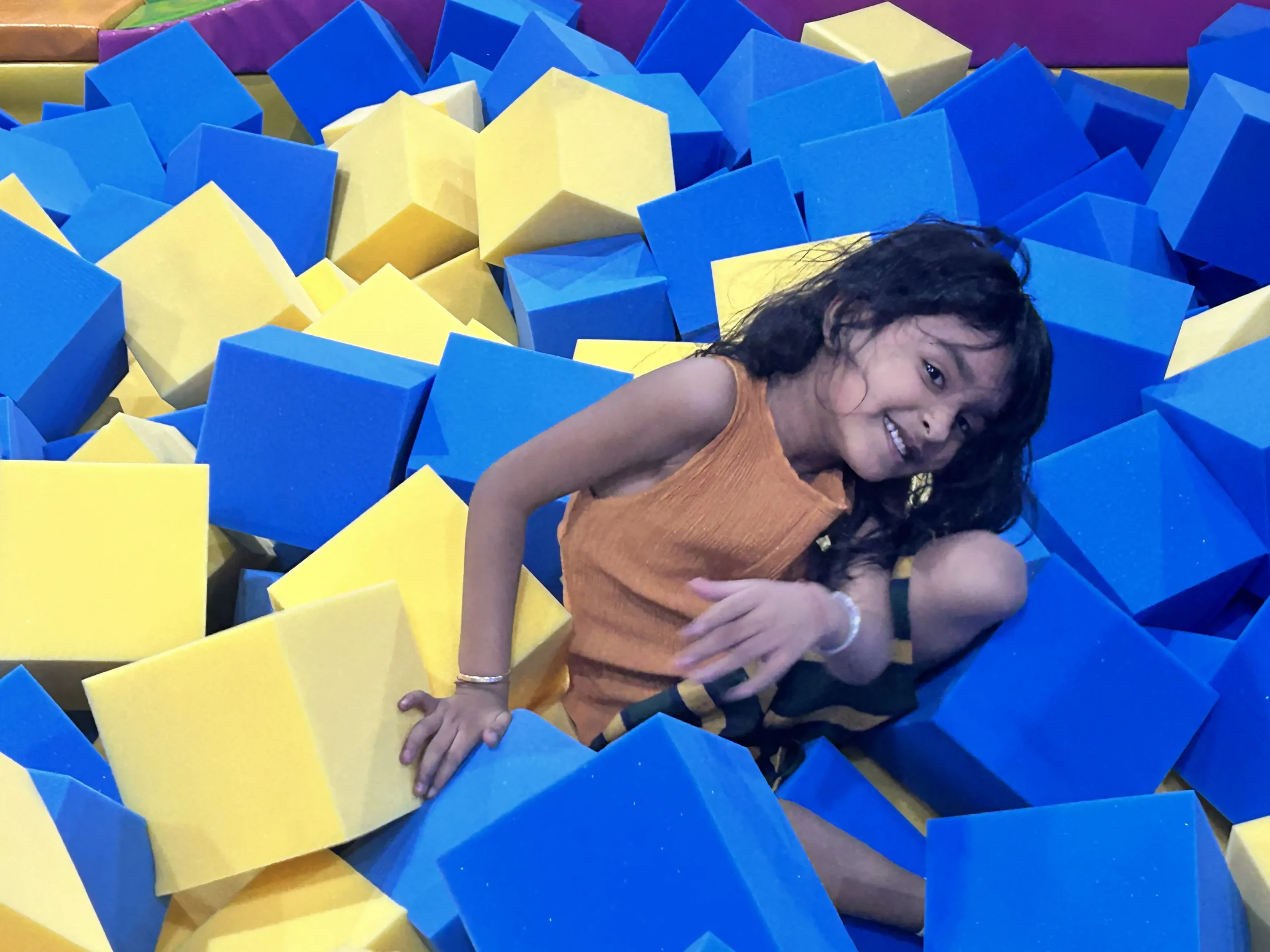 a girl playing in foam pit at skyjumper