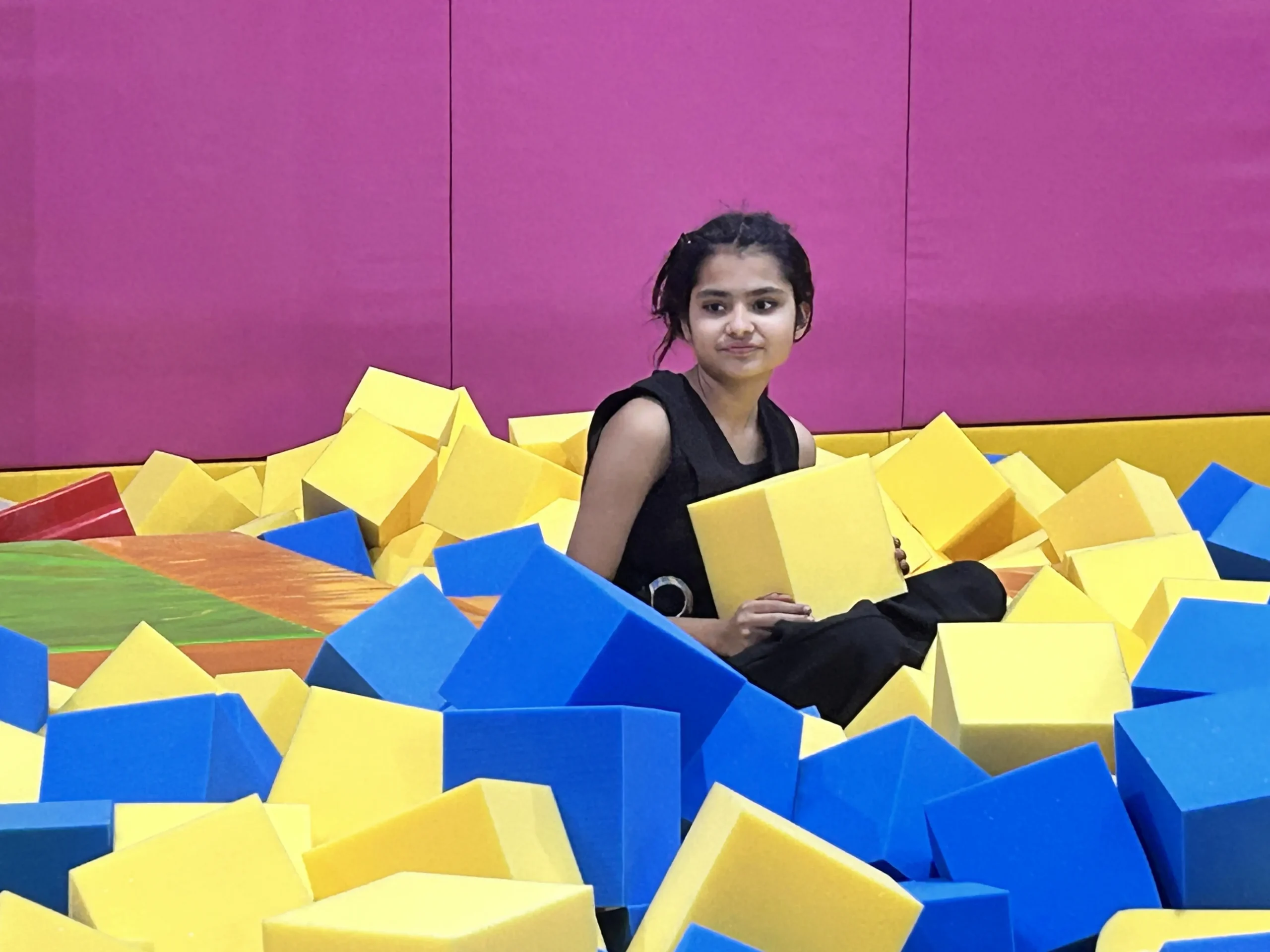 a girl sitting in foam pit at ghaziabad skyjumper
